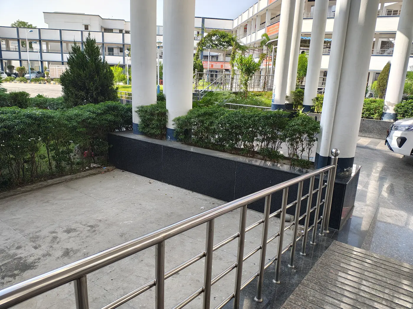 Hospital entrance with a ramp and steel railing