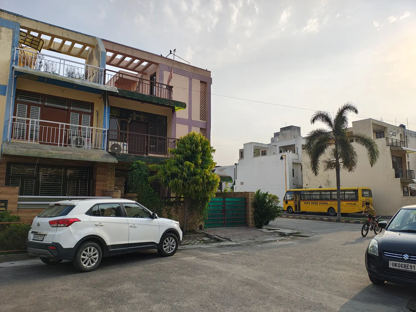 Residential street with a school bus and parked cars